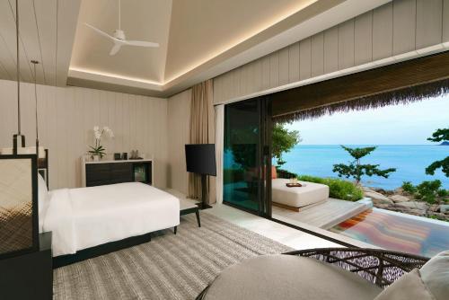 a bedroom with a bed and a view of the ocean at Hyatt Regency Koh Samui in Chaweng