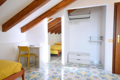 a bedroom with a bed and a desk and a chair at B&B IL BIVIO SUI SENTIERI in Pianillo