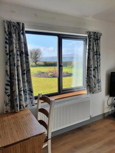 a window with a view of a field at Roaringwater Stay in Skibbereen