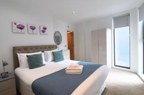 a bedroom with a bed with towels on it at Tooley Street Apartments by Viridian Apartments in London