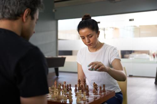 a woman playing a game of chess at Ikshana Resort and Spa, Khandala in Lonavala