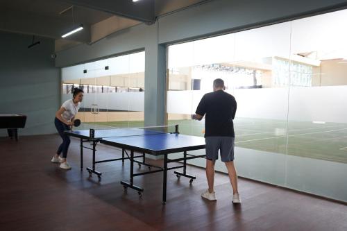 two people playing a game of ping pong at Ikshana Resort and Spa, Khandala in Lonavala
