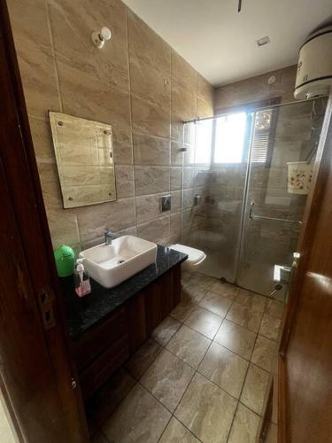 a bathroom with a sink and a shower at Kamz Homestay Chandigarh 35 in Chandīgarh