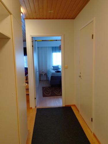 a room with a bed and a door leading to a bedroom at Varakoti Iines in Loimaa