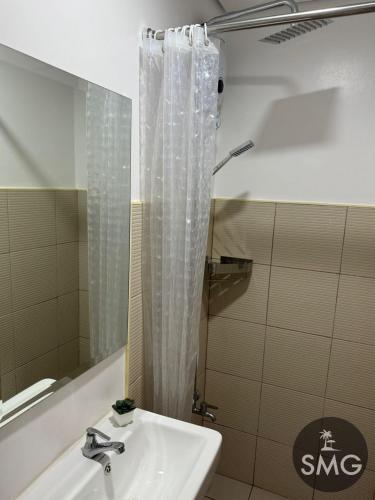 a bathroom with a sink and a shower at SMG - Studio@Green2: Wi-fi, Netflix, Swim & Relax in Cavite