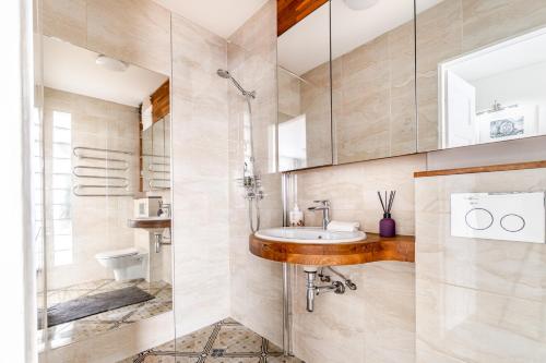 a bathroom with a sink and a shower at Angel House Vilnius, Skroblu 39 in Vilnius