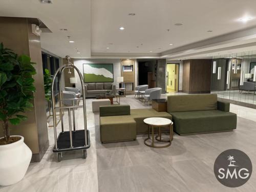 a hospital lobby with a waiting room with green chairs and a waiting room at SMG - Studio@Green2: Wi-fi, Netflix, Swim & Relax in Cavite