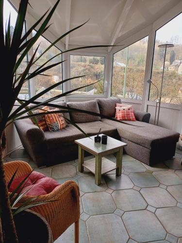 a living room with a couch and a table at Gite Villa le Monde - La Roche-en-Ardenne in La Roche-en-Ardenne