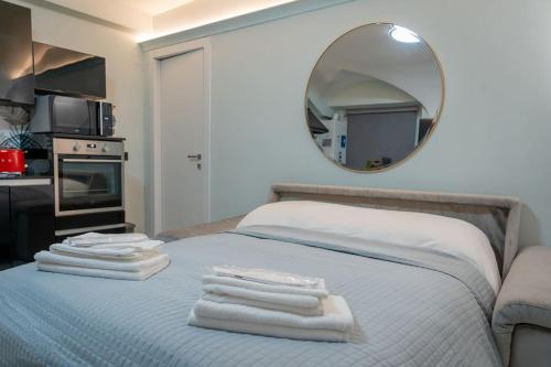 a bedroom with a bed with a mirror on the wall at Casa Ela in Genova