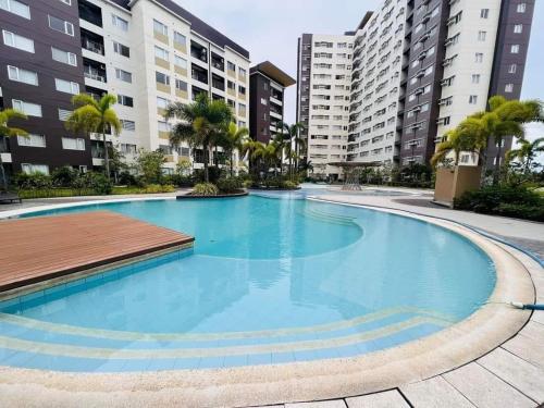 an empty swimming pool with buildings in the background at Avida Tower 1 L21 staycation rm1002 in Iloilo City
