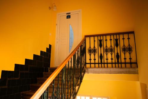 a staircase with a white door and a surfboard at Apartment Primula in Subotica