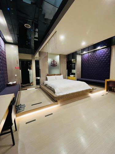 a bedroom with a large bed and a desk at Walker Motel in Taipei