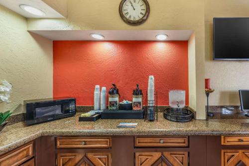 a kitchen counter with a clock on a wall at Best Western Americana Inn in San Ysidro, San Diego