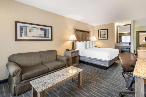 a hotel room with a bed and a couch at Best Western Americana Inn in San Ysidro