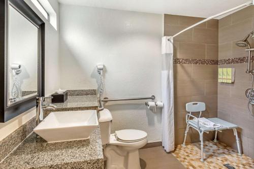 a bathroom with a toilet and a sink at Best Western Americana Inn in San Ysidro