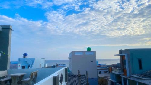 a view of the roofs of buildings with a cloudy sky at Homestay Hoàng Phúc in Cu Lao Thu