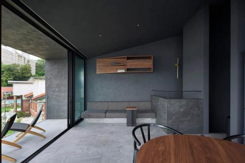 a living room with a table and a couch at Seaside Villa SEEN Deep Sea in Onomichi