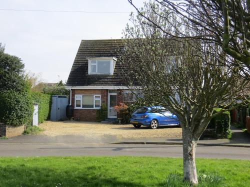 a blue car parked in front of a house at Rowan House in Hunstanton