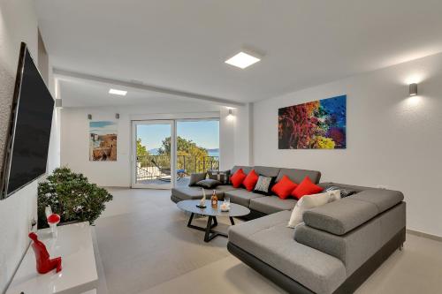 a living room with a couch and a table at Luxury Apartments Podgora in Podgora