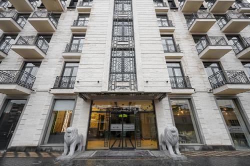 un edificio con dos leones delante de él en Hotel Dynasty en Ereván
