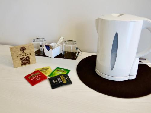 a white coffee pot sitting on top of a table at Agriturismo Forest B&B in Iseo