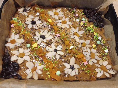 a chocolate cake with flowers on top of it at Agroturystyka Przy Siole Budy in Białowieża
