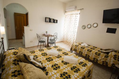 a living room with two couches and a table at Imperium in Tropea