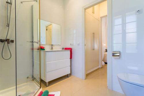 a white bathroom with a sink and a shower at Casa Vileta in Palma de Mallorca
