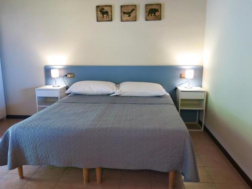a bedroom with a large bed with two pillows at Agriturismo Forest B&B in Iseo