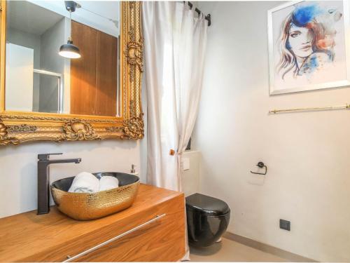 ein Badezimmer mit einem Waschbecken und einem Spiegel auf einer Kommode in der Unterkunft Beautiful Villa Una Sofia with pool in Tinjan in Vela Traba