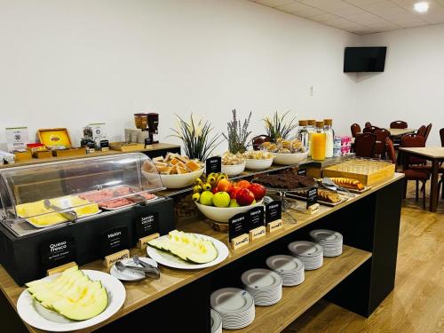 a buffet line with many different types of food at Duerming Villa de Arzúa in Arzúa