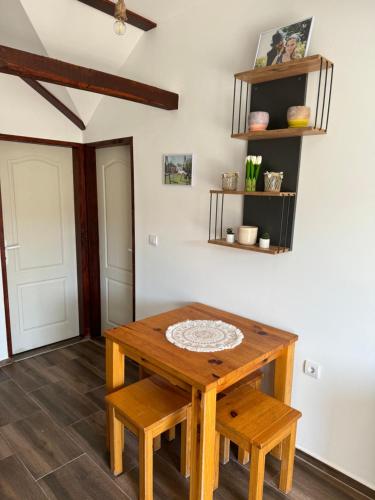 a room with a wooden table and two benches at Brvnara Ruza Rumena in Mionica