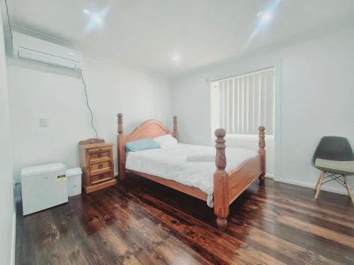 a bedroom with a bed and a dresser and a window at Kaban Power 39 in Bidwill