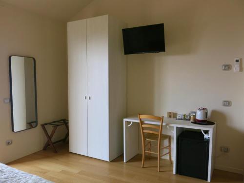 a bedroom with a desk and a white cabinet at Agriturismo Forest B&B in Iseo