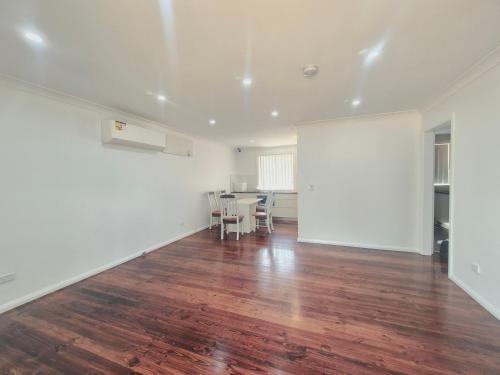 an empty living room with a table and chairs at Kaban Power 39 in Bidwill