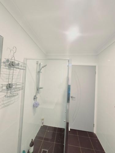 a bathroom with a shower with a glass door at Kaban Power 39 in Bidwill