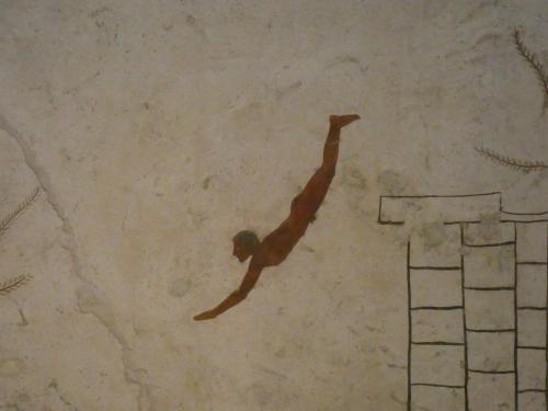 a man is diving into a swimming pool at Villa Giulia - Cilento - Giungano in Giungano