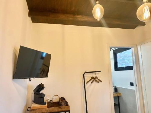 einen Flachbild-TV, der an einer Wand hängt in der Unterkunft Sotto L'Ulivo in Montepulciano