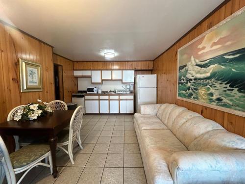 a living room with a couch and a table and a kitchen at Wilmington Terrace in Ocean City