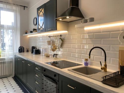 a kitchen with a sink and a counter top at Medusa Apartment in Krakow