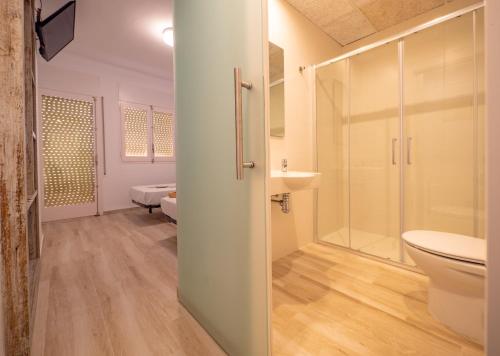 a bathroom with a shower and a toilet and a sink at Agi Gloria Rooms in Roses