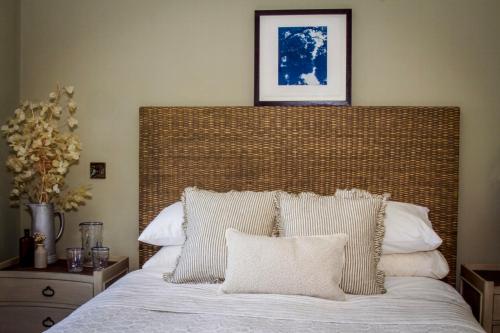a bedroom with a large bed with white pillows at Nest Farmhouse in Docking