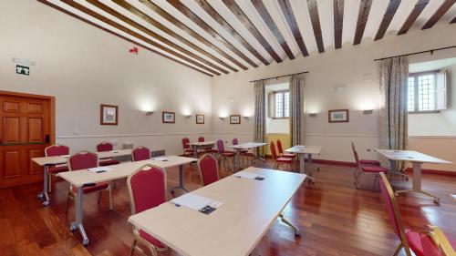 a classroom with tables and chairs in a room at AZZ Peñafiel Las Claras Hotel & Spa in Peñafiel