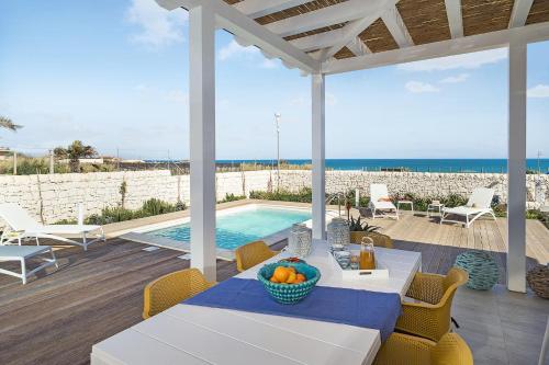 a patio with a table and chairs and a swimming pool at San Lorenzo - Timo in San Lorenzo