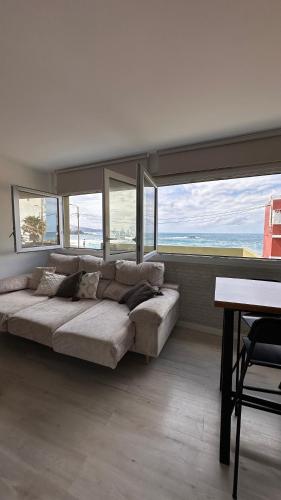 a large couch in a room with large windows at Blue Sea in Moya