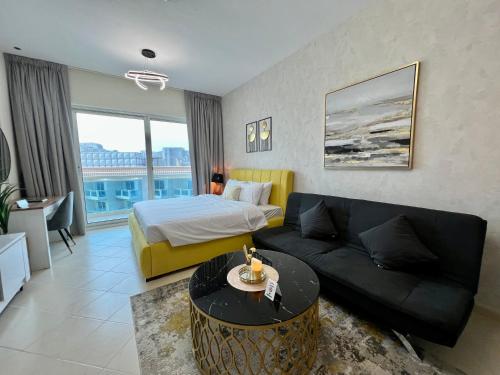 a hotel room with a bed and a couch at Cosmos Living Stunning Apt in Lago Vista IMPZ in Dubai