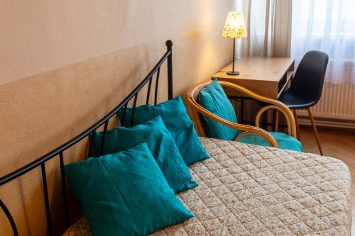 a hotel room with a bed with blue pillows at Hotel Atlas in České Budějovice