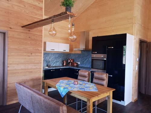 a kitchen with a wooden table and chairs and a dining room at Ferienwohnung Am Roten Berg in Peiting