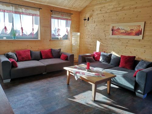 a living room with two couches and a coffee table at Ferienwohnung Am Roten Berg in Peiting
