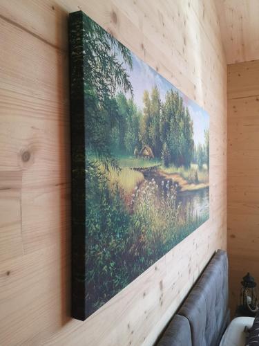 a painting hanging on a wall with a couch at Ferienwohnung Am Roten Berg in Peiting